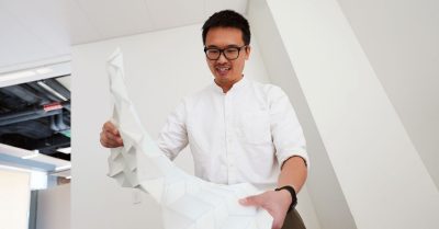 Suyi Li with large origami piece