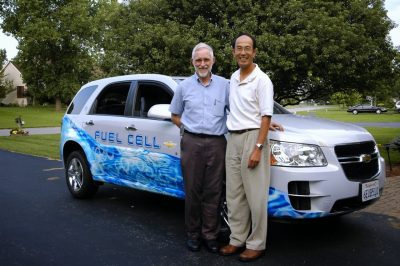 Dave Dillard (left) and Yeh-Hung Lai stand in front of a GM car with "fuel cell" written on it