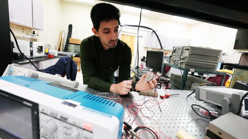 Graduate Research Assistant Moustafa Sayed Ahmed holds a device used for ultrasound power transfer in the lab of Shima Shahab.